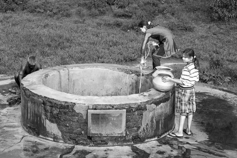Children fetching water from a deep well in a village in Jharia coal fields, Dhanbad district, Jharkhand